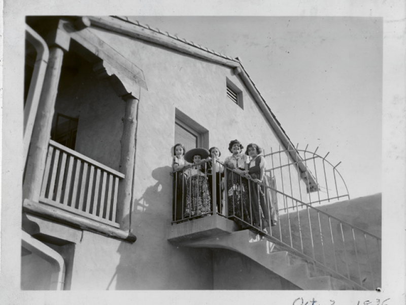 A group of girls pose at the top of external stairs at the Guadalupe Center